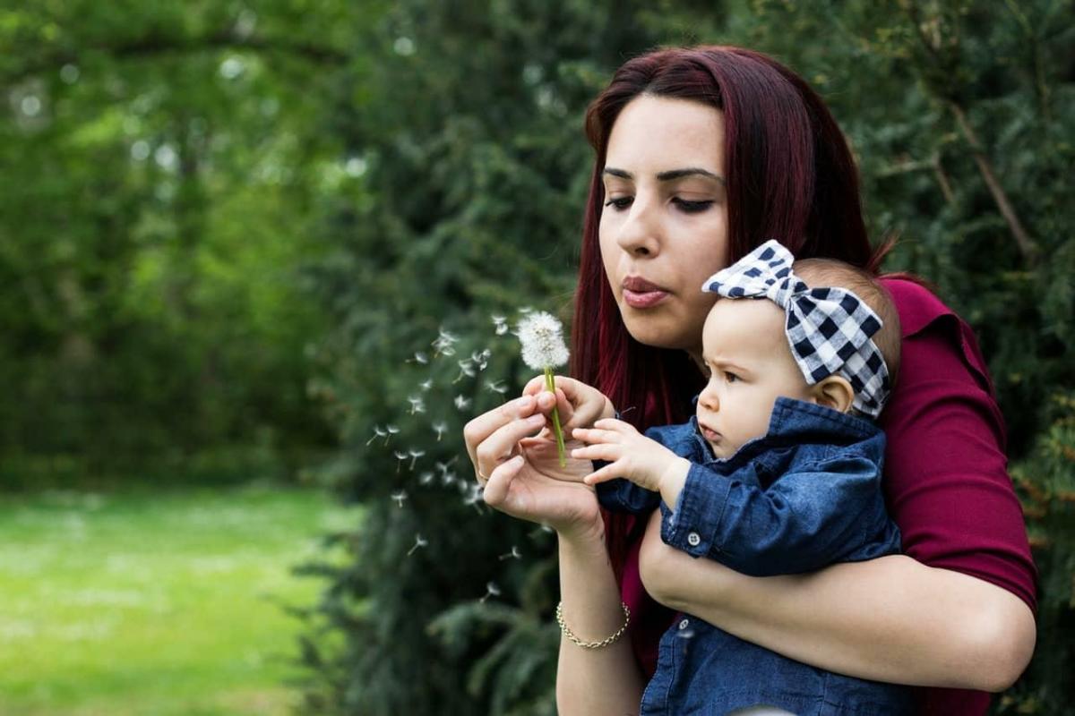 a mother playing with her baby