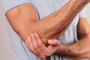 a person experiencing tennis elbow pain