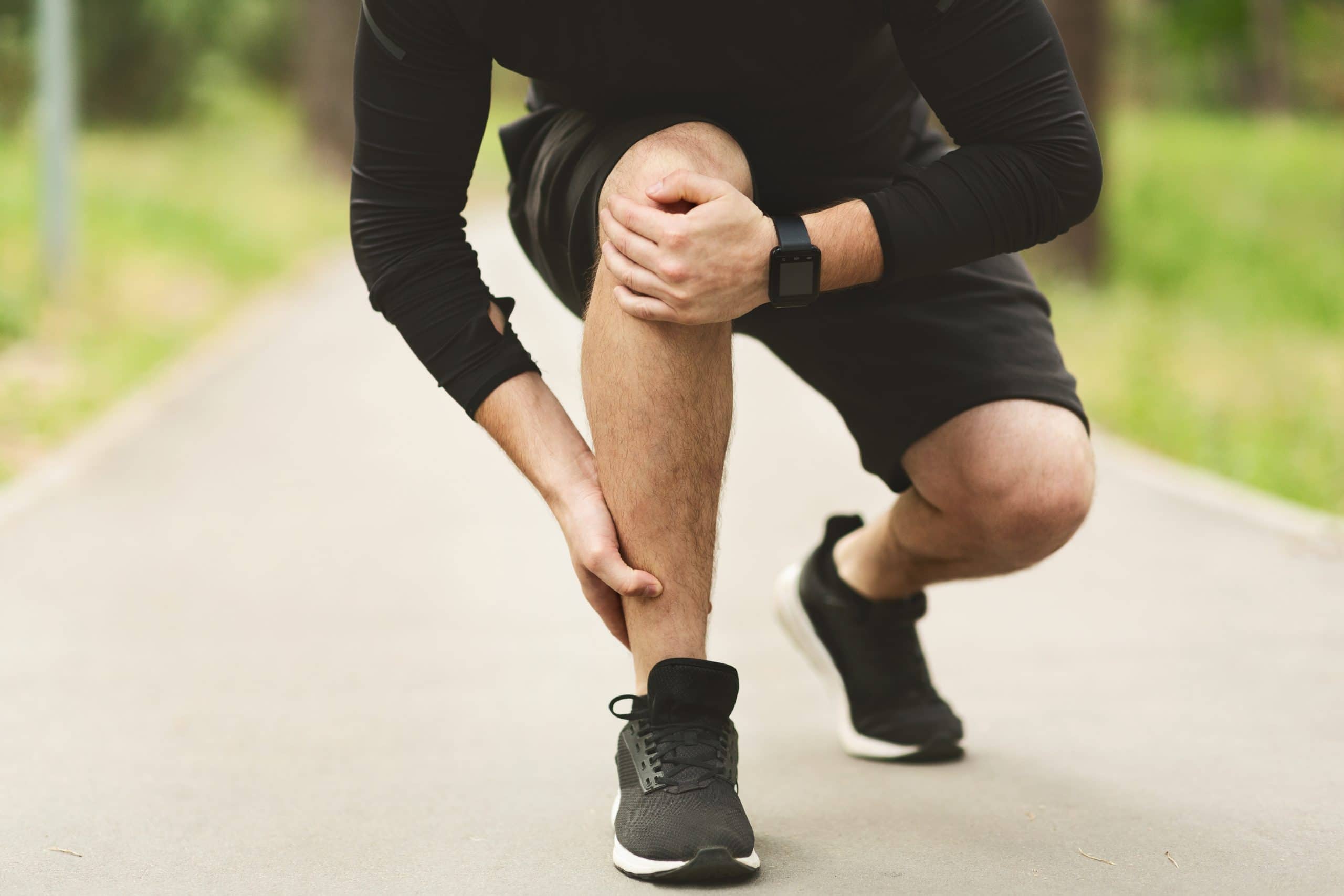 Male runner is suffering from ankle pain.