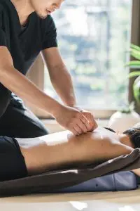 patient receiving acupuncture treatments on their upper back 