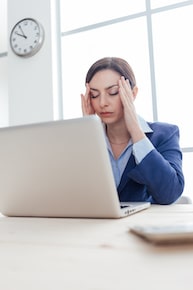 Female business woman holding her head