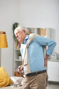 senior man holding his back due to pain