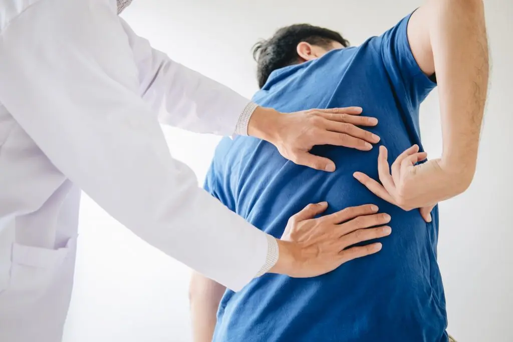 patient showing doctor his back pain