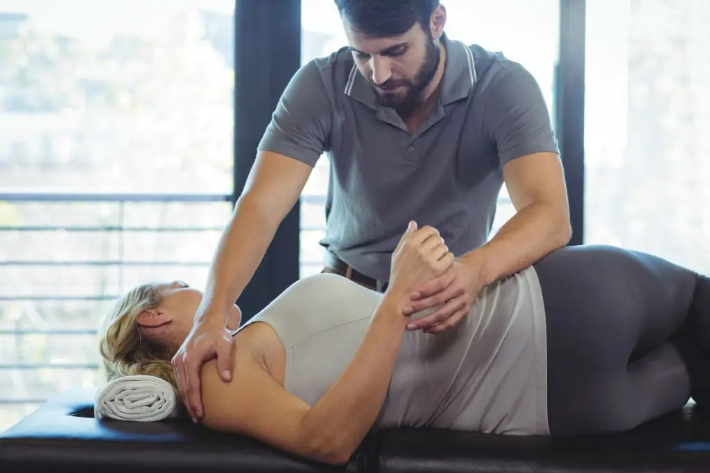 chiropractor adjusting female patients - Herniated, Thinning & Bulging Disc Treatment in Knoxville