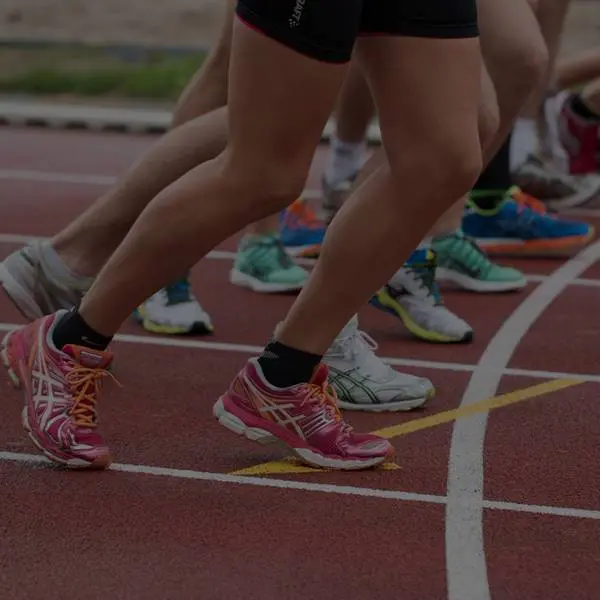 cropped image of runner's on track