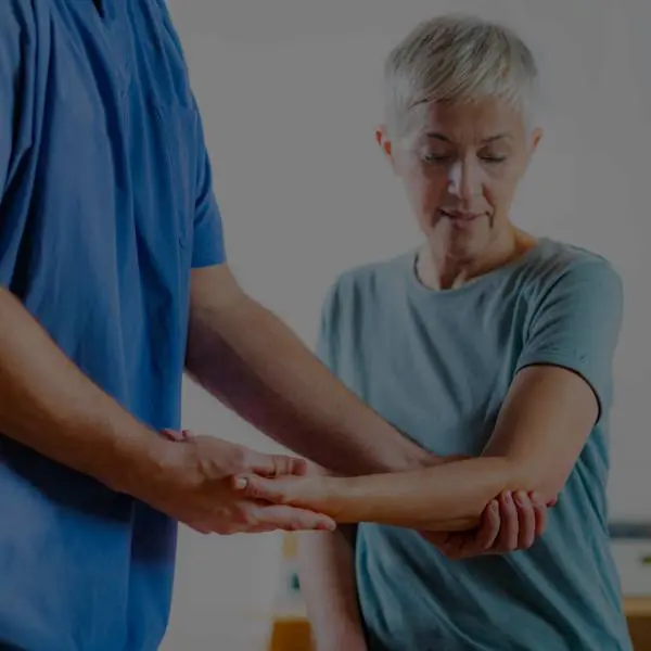 elder woman getting physical therapy from a therapist