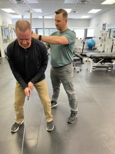 golfer patient getting treatment from golfer's elbow