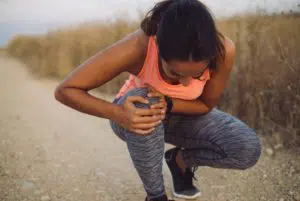 Female athlete suffering form running knee pain
