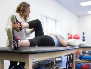 Physician doing therapeutic exercises for an elderly patient. Kinesitherapy at the medical center.