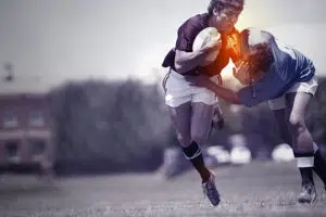 rugby player being tackled during a game and sustaining shoulder injury