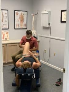 chiropractor examining a patient's knee