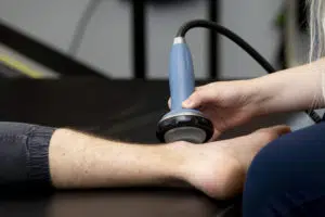 patient's foot being treated by the shockwave therapy machine