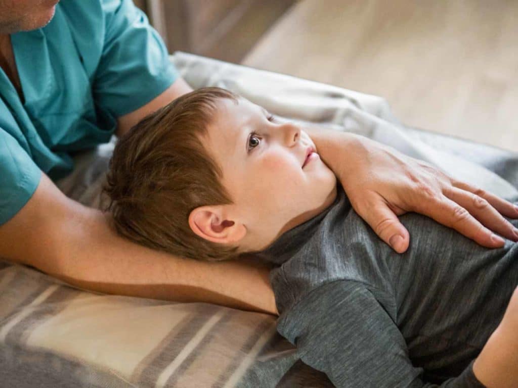 Child getting chiropractic treatment