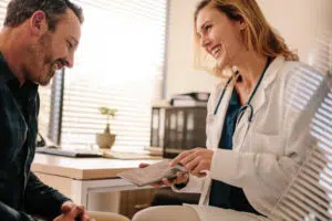 Female Chiropractor is having a conversation with a patient regarding the medical insurance