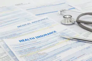 Medical insurance documents and stethoscope 