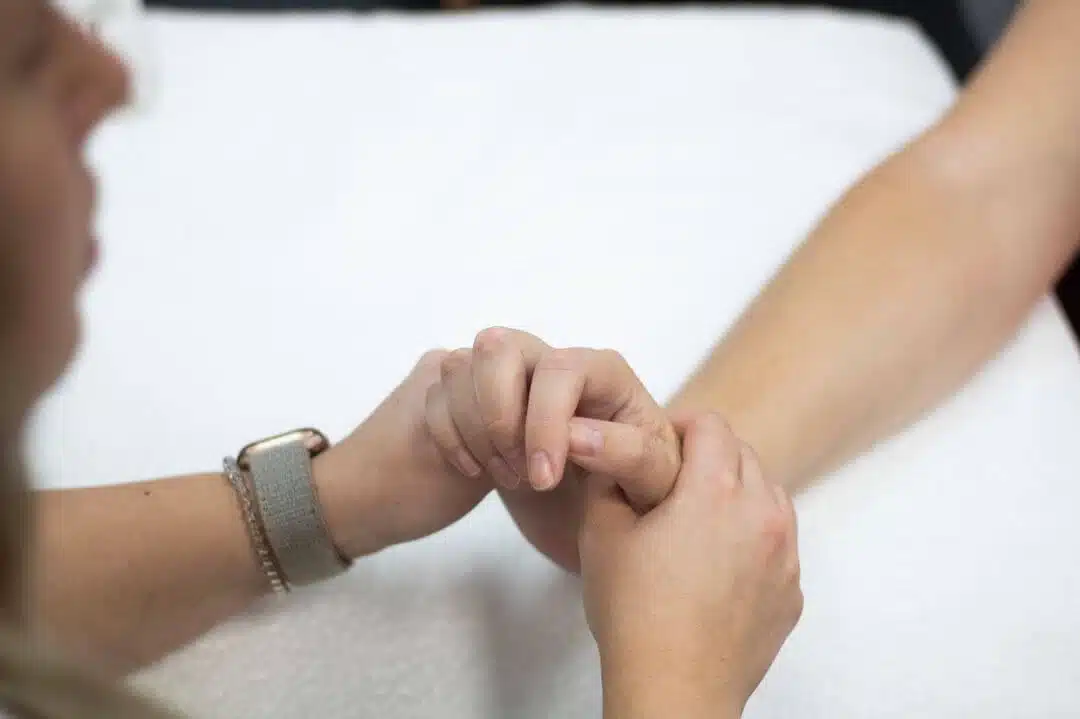 Physical Therapist squeezing a patient palm