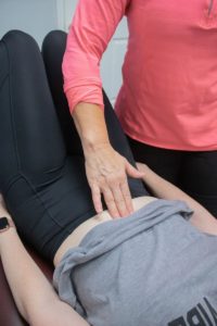 Physical Therapist checking for a diastasis