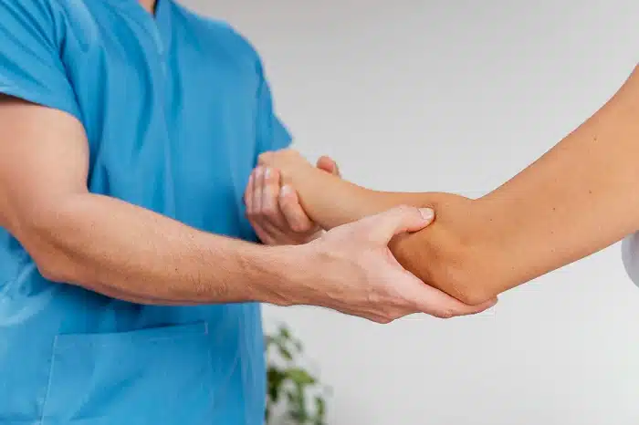 Chiropractor assessing patient's joint pain