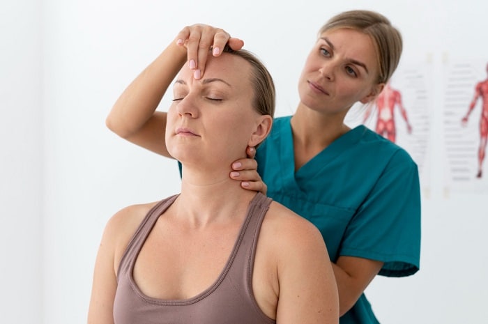 Person receiving a chiropractic neck adjustment for headache relief