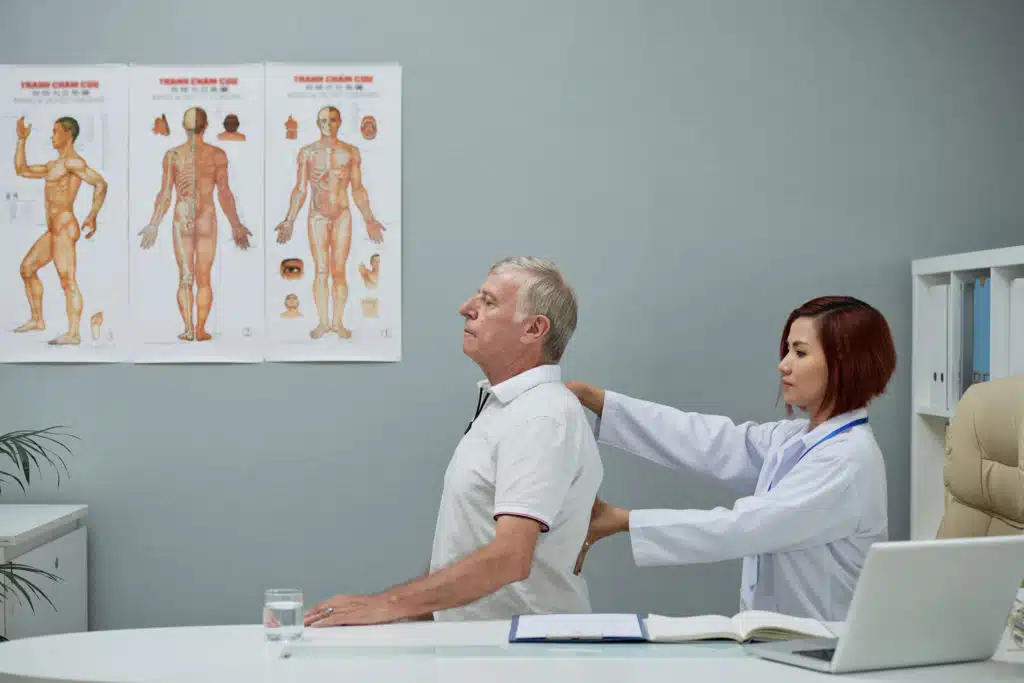 a doctor who's checking the posture of the patient.