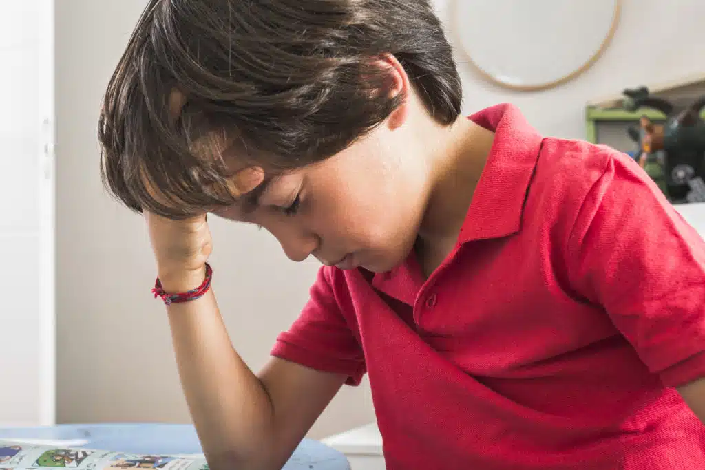 little kid putting hand head - Physical Therapy and Chiropractic Care