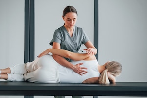chiropractor doing spinal adjustment on patient for role of physical therapy and chiropractic care