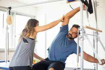 physical therapist coaching patient with stretching exercises for role of physical therapy and chiropractic care