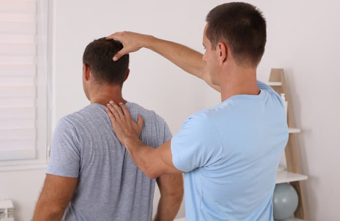 hysiotherapy. Man Chiropractic pain relief adjustment